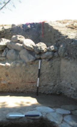 This channel, or drain, has a flat base and four handles and was found on a white-yellow prepared clay surface spread over a layer of beach pebbles.