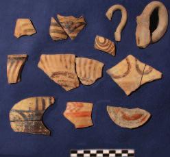 Late Minoan sherds were found in trench G1000. a circle of small depressions for cult food offerings incised on one of its stones.