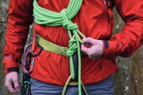 Take this loop down and around the back of the rope leading up from the knot on your harness.