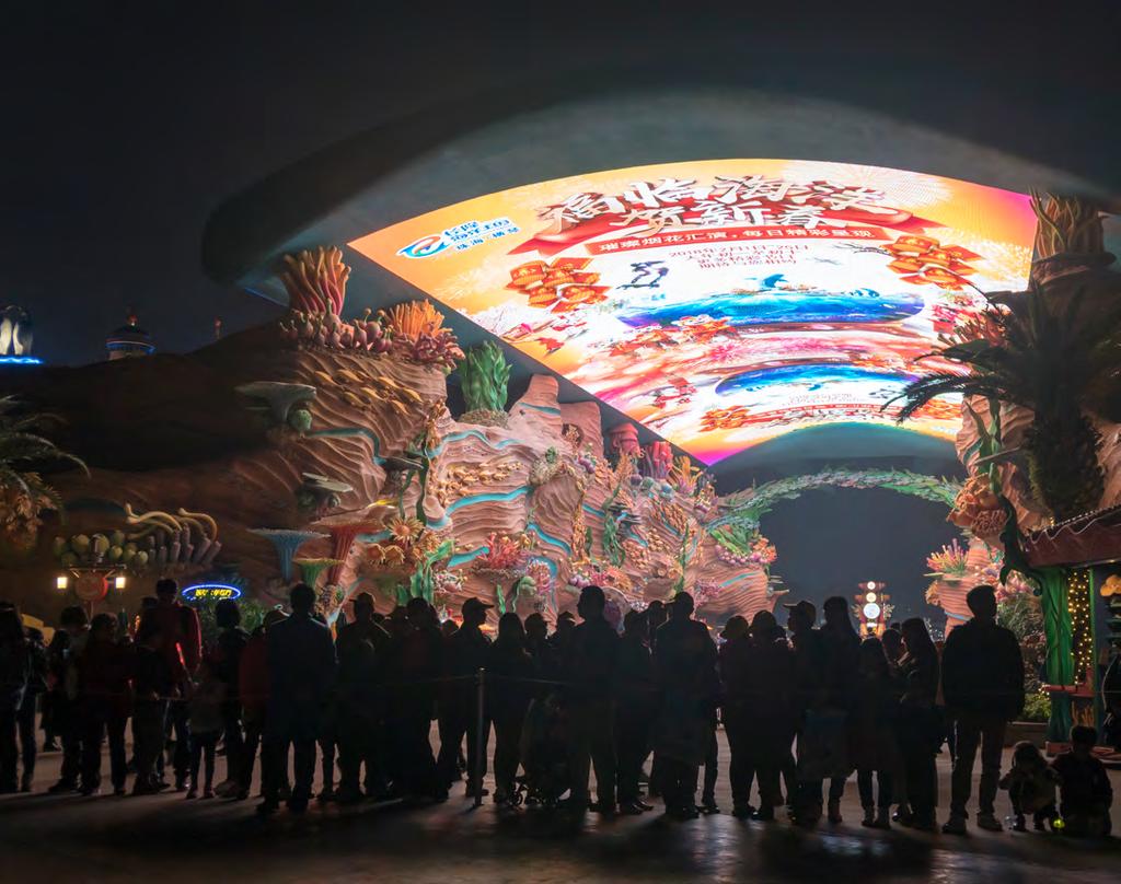 China business Hong Kong-Zhuhai-Macau Bridge Tourists walk under a huge LED screen displaying videos of marine life at the Chimelong Ocean Kingdom, the largest ocean theme park in the world, in