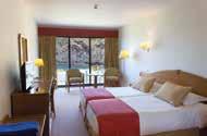 The hotel has a magnificent setting on a rocky promontory overlooking the sea and is set against a background of small fields and