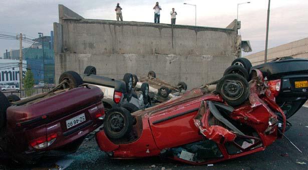 Collapsed bridge with overturned cars in
