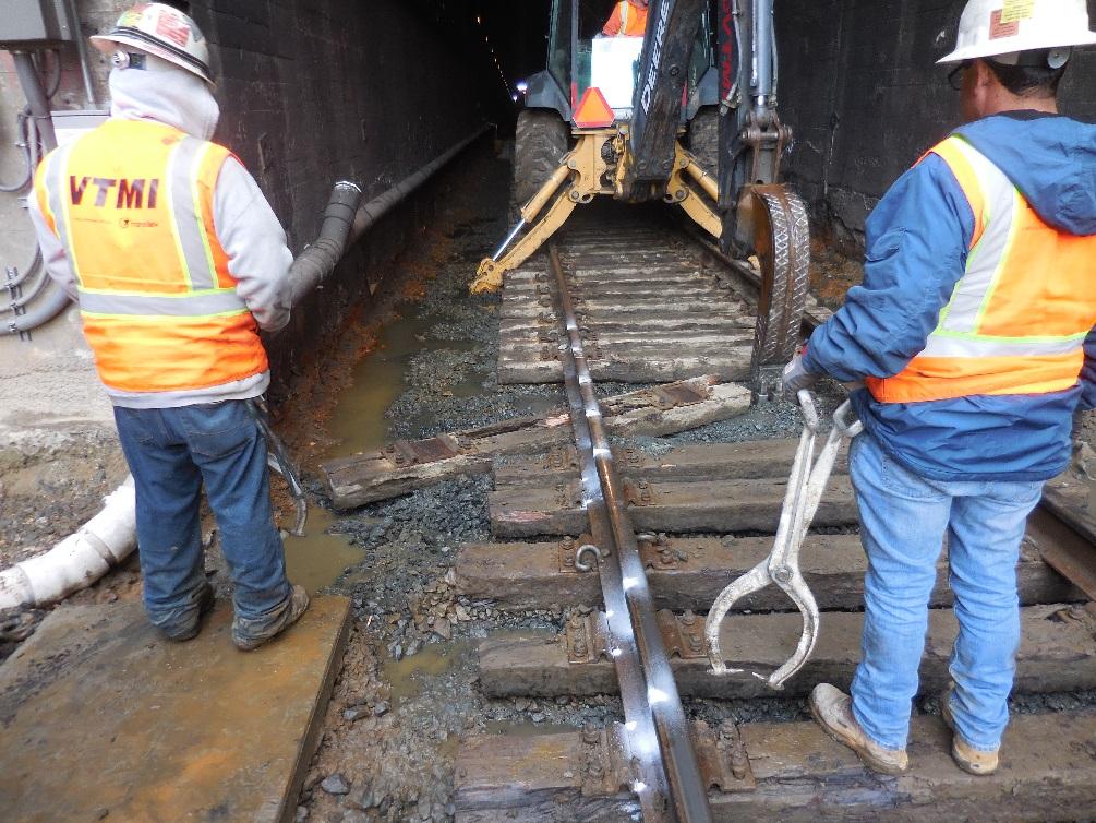 Figure 12 A track work group removing an old tie at the West portal of