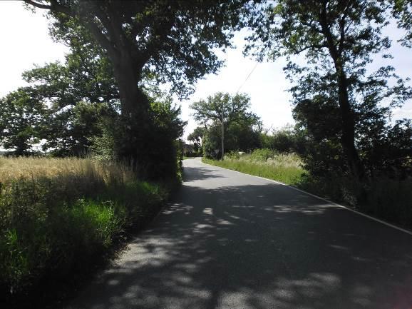 Photo 1: View when travelling along Buck Hill towards the junction with Bakers Lane 5.