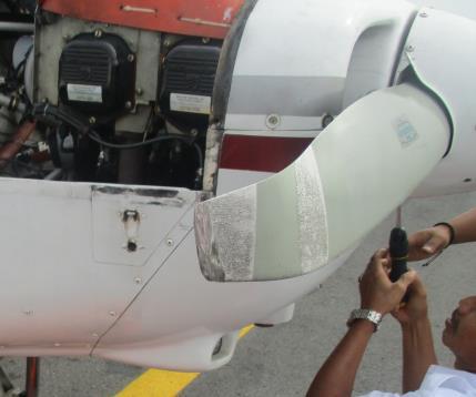The lower engine cowling scratch; b.