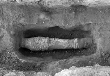 the wall by lime mortar (traces still evident on the wall face) and ended in pool X. In shop B1, two long sections of this pipe were preserved, concealed under the limestone flagging on the floor.