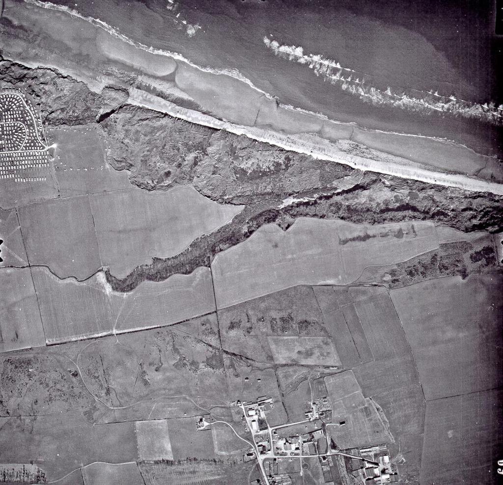 Fig. 4 - Air photograph taken in 1969 showing the defence area. Speeton village lies at the bottom, with the wooded Old Beck running across the centre.