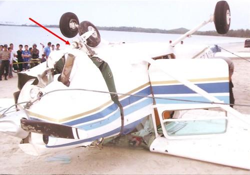 Figure 3: Arrow points to fractured nose landing gear The main and nose landing gear assemblies were substantially damaged.