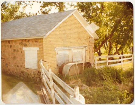 The stone milk house. The photo above shows the side door which we would open each evening after milking to place the 10-gallon-filled milk cans for cooling into about 2-plus feet of cold water.