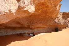 Drive a short distance to Jebel Uweinat where we visit Karkur Talh main rock art site then continue