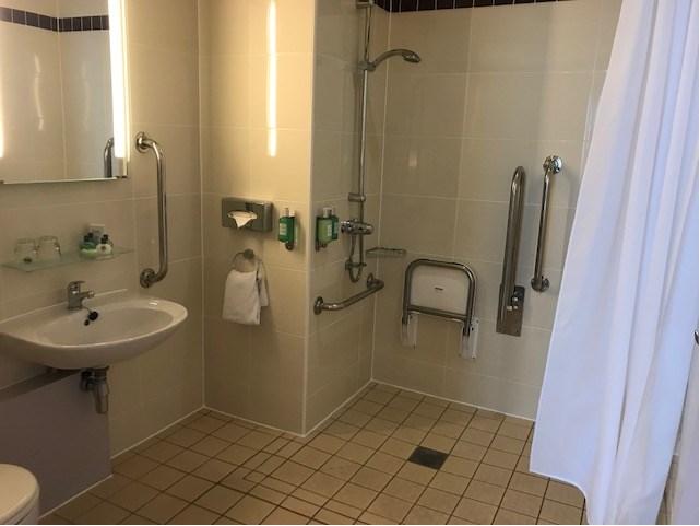 In fully accessible bathrooms the shower is separate, in the partly accessible bathrooms the shower is above the bath.