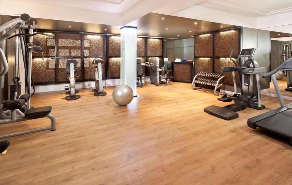 A multifunctional space including technogym equipment, stretching area, lockers