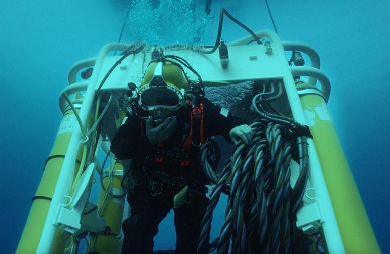 CLOCKWISE FROM TOP LEFT: U-Boat Navigator at sea in Malta; U-Boat Navigator crew prepares a diver for a dive in a hard-hat diving helmet; Hard-hat diver in the U-Boat Navigator diving bell; Triton