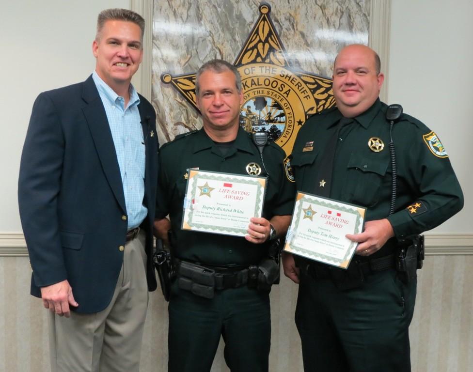 TWO OCSO DEPUTIES EARN LIFESAVING AWARD Sheriff Larry Ashley presented Lifesaving Awards to two Okaloosa County Sheriff s Deputies who went to the aid of an unconscious individual at Destin Commons