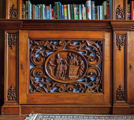 This room has carved book cases, a baronial carved fireplace and a carved door dated 1683.