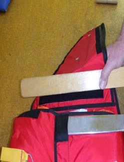 assist in dressing out the closed container with a packing paddle.