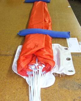 Fully Flat Packing Instructions Step F1 Follow Steps 1-4 on page 16 under 360 / 425 / 490 BACK PARACHUTE; then take each side of folded canopy and fold again past center.