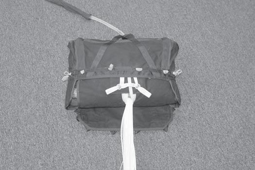 Stow the pilot chute on the inside of the outer deployment bag using Keener Rubber Company 2 X 3/8" (standard size) bands or equivalent. Cut rubber band in half length wise, making it 2 X 3/16.