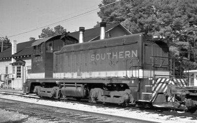 Southern Railway engine #1044 idles in front of Havelock depot. The A&EC "Fallen Flag" designator is barely visible beneath number on locomotive cab. View is to the east with locomotive facing south.