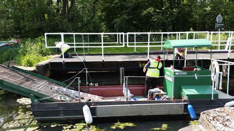 Working party volunteers repainting No. 4 Swingbridge The PCAS weed cutting boat has been used for a variety of jobs in addition to cutting weed.