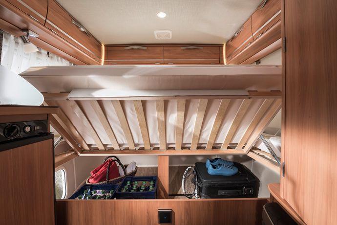 Concealed under the fixed rear transverse bed in the sleeping area of the ERIBA Touring Familia 310,