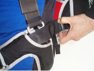 Loosen the lateral strap by pulling the strap backward.