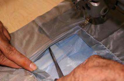 Place the parachute fabric behind the fold back of the patch forming a French fell seam.