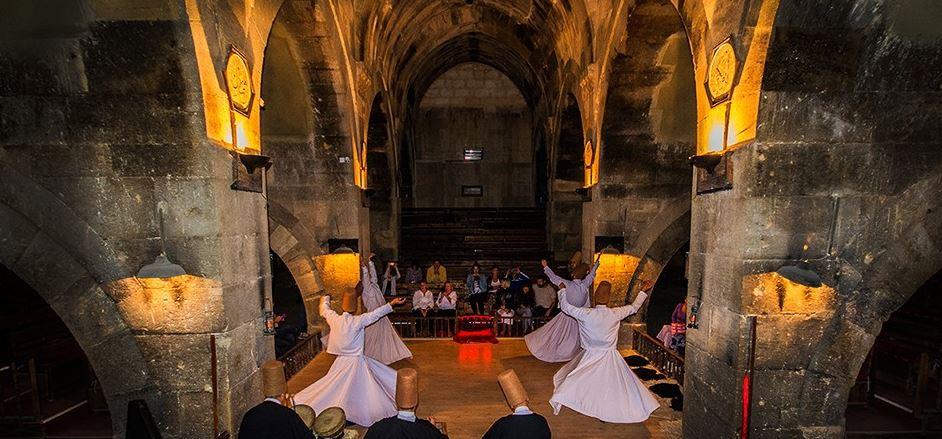 The dance is enchanting and the setting couldn t be more perfect as it is performed inside a 13th century renovated Silk Road caravanserai.