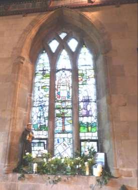 (L) This corner of the church is where the roll of honour and war memorial tablet are located. (R) Hoby s WW1 memorial window dressed as part of the Flower Festival.