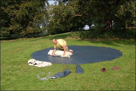 10) Take one side and fold over towards the middle so the edge ends up in the middle of the tent.