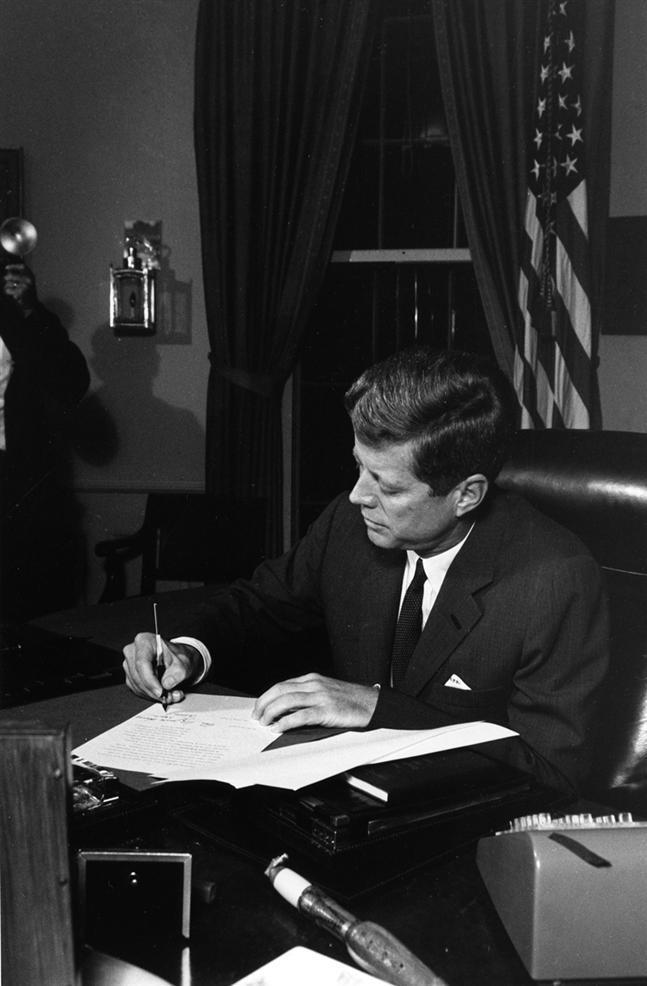 President Kennedy signing the bill to
