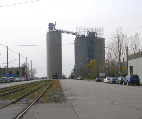 First silos completed in 1920, now Essroc Toronto Terminal, formerly Century Coal Company Limited (1920-1960s), and Lake Ontario Portland Cement Company.