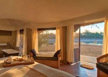 Where You'll Stay Mchenja Bush Camp With only four specially designed octagonal canvas and thatched chalets built on concrete bases, and even a self-contained tented suite for families - Mchenja is