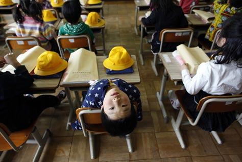 REUTERS/AFLO New pupils attend their first homeroom activity after an entrance ceremony at Kamaishi Elementary School in Kamaishi, Iwate Prefecture, April 20.