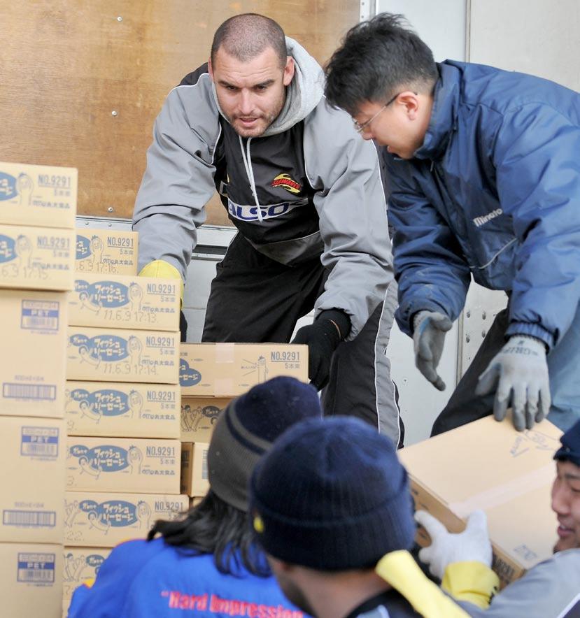 AFLO Kamaishi Seawaves star Scott Fardy helps fellow volunteers unload relief supplies from a truck in the tsunami-stricken town, March 18. we knew we could help in some way.