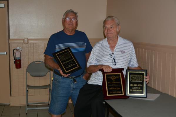 Bob Whitney and Dave Platt display their awards, earned from attending