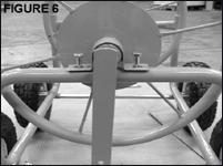 6. Place the spool (B) on the frame so the bushings are oriented over the holes on the frame.