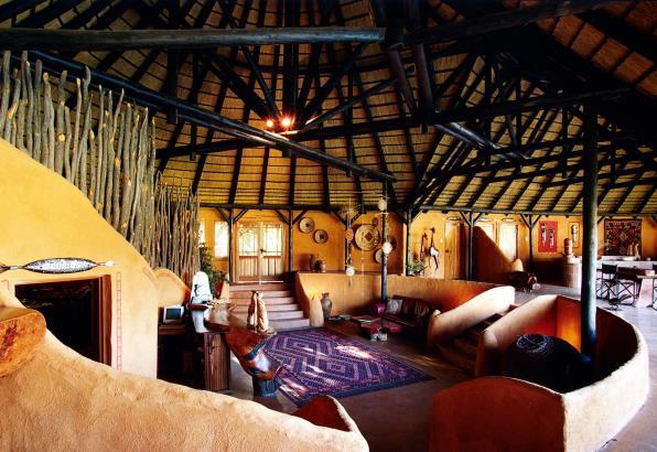 The Honeymoon Suite boasts a stunning view, a sliding glass door, 2 Queen-size beds, and a comfortable en-suite lounge with fire-place, a bath and outside 'bush' shower.