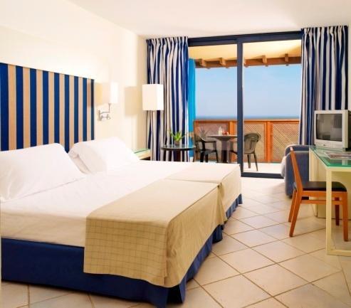 They have a double bed and can accommodate up to 2 adults + 1 baby. You may request a Double Room with side sea-views ($).