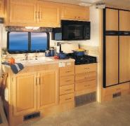 Interior photography features Model 39R shown in Shaded Ice with Fairfield Maple optional wood. Meals are a snap in Bounder Diesel s galley.