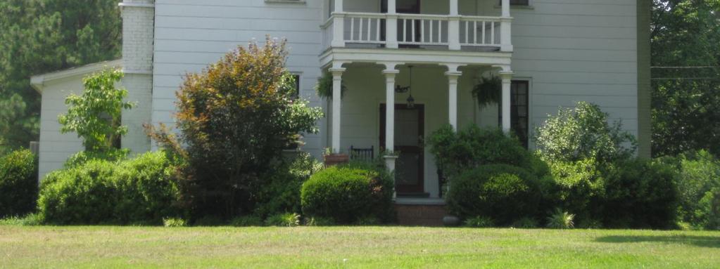 1803 This Federal period home features a central two-tiered portico with unusual carved blocking between Doric posts and the fascia or pediment they support.