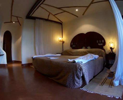 Maasai village, the lodge features thickly-thatched, stone-built rooms,