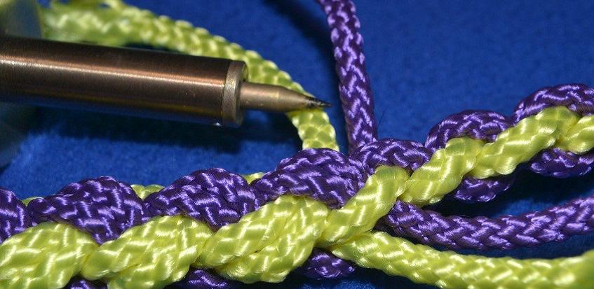 Using pliers, open the split ring and run it between two strands of the cordage.