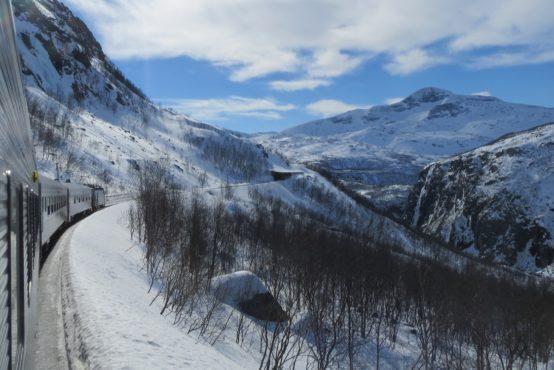 Once you cross into Norway enjoy the magnificent views and try to take photos before continuing up and over Björnfjell a stunning Norwegian mountain dotted with small grass roofed cottages.