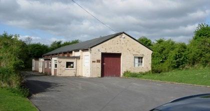Detached brick industrial unit with pitched felt covered