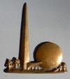 Estimate: $ 75-25 0 Lot # 421 - Brass Trylon and Perisphere. This piece has a hole in the back that must have been used to attach this piece to something else. Size: 2 1/4" wide by 2 1/2" high.