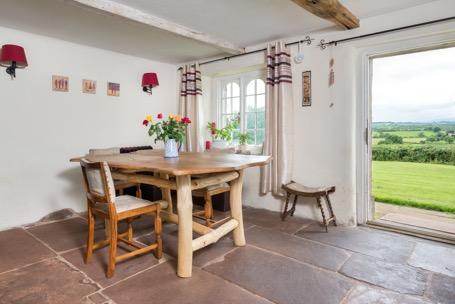 dining-kitchen and sitting room with wood burning stove and