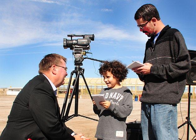 Below: Secretary King is interviewed by junior reporter Liam Murphy, 7-year-old son of Emporia Gazette reporter Jesse Murphy (right) after the grand opening. Trivia! Ice Hockey 1.