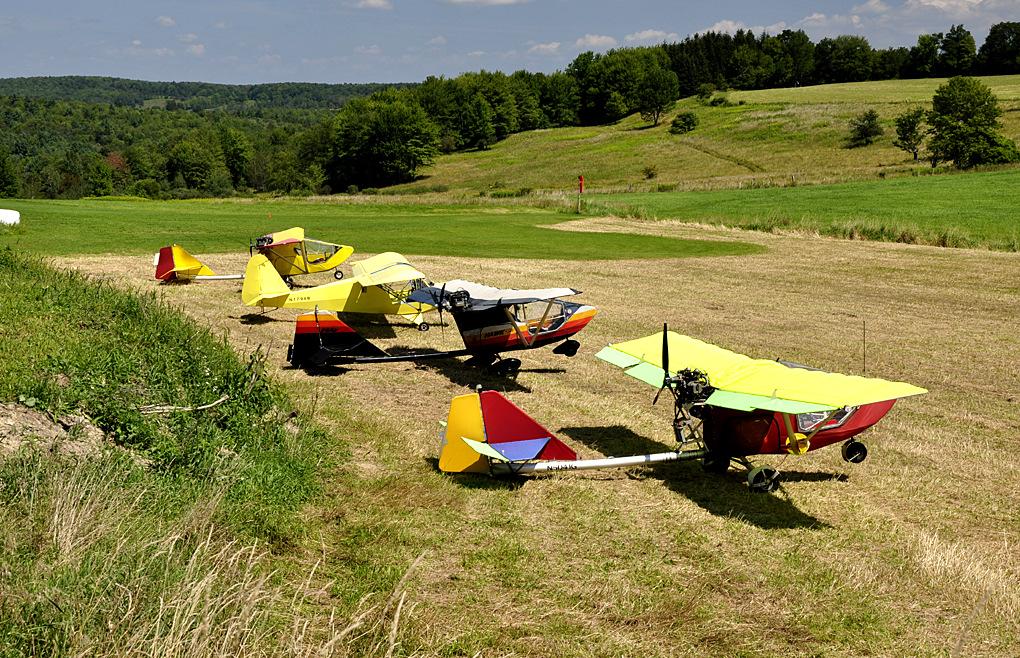 Fifty feet behind these planes stands the classic, large red New England barn with silo, farmhouse and assorted farm implements. Only 2 of these Ultra-Lights had tail numbers.
