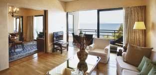 The separate lounge area, a spacious bedroom, a dining room and a kitchenette are adjoined in the Grand Suite Sea View.